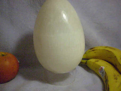 6.5 inch tall selenite egg. Exhibits fibrous chato