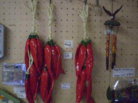 Clusters of red ceramic chilis (ristras). Each clu