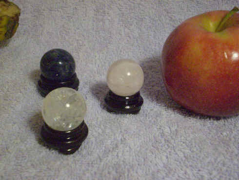 Stone spheres with lacquered wooden stands.