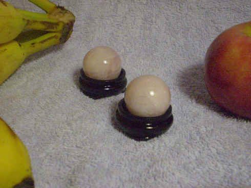Rose quartz spheres with included lacquered wood s