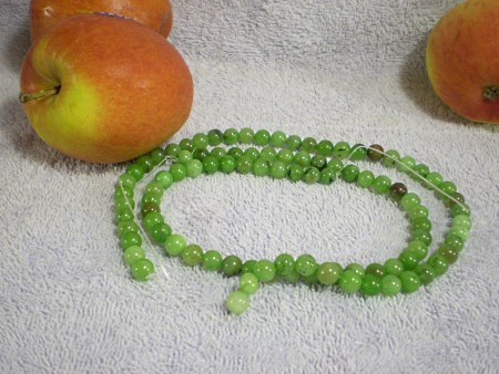 Green beads, possibly emerald (D) or onyx (D).